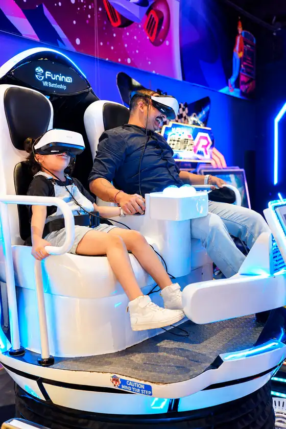 A player wearing a VR headset in a motion seat